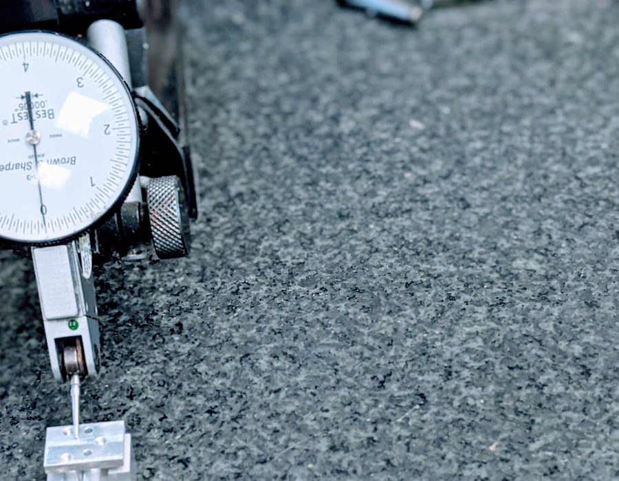 Dial indicator measuring a part on a granite surface plate